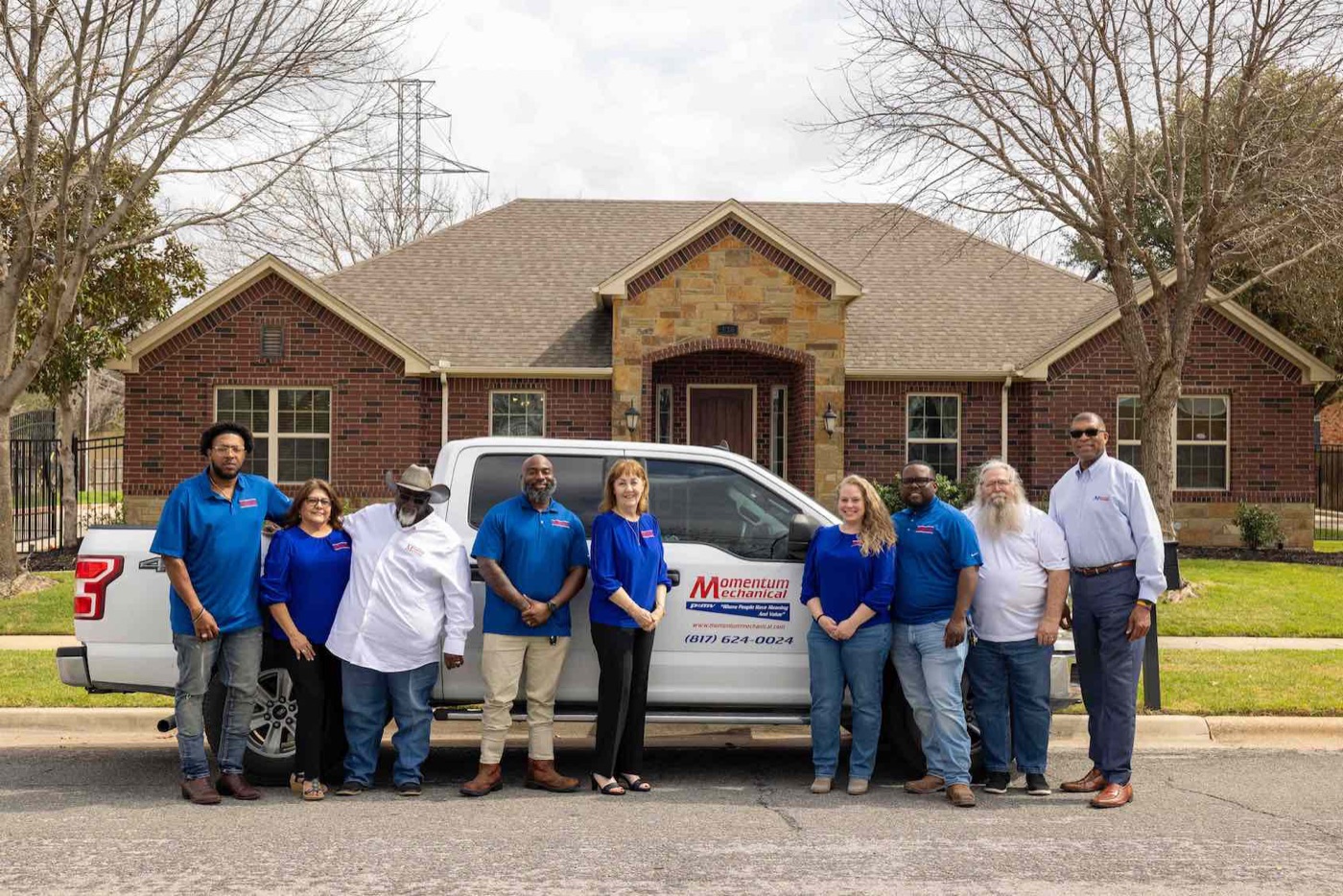 The Momentum Mechanical team in front of company truck